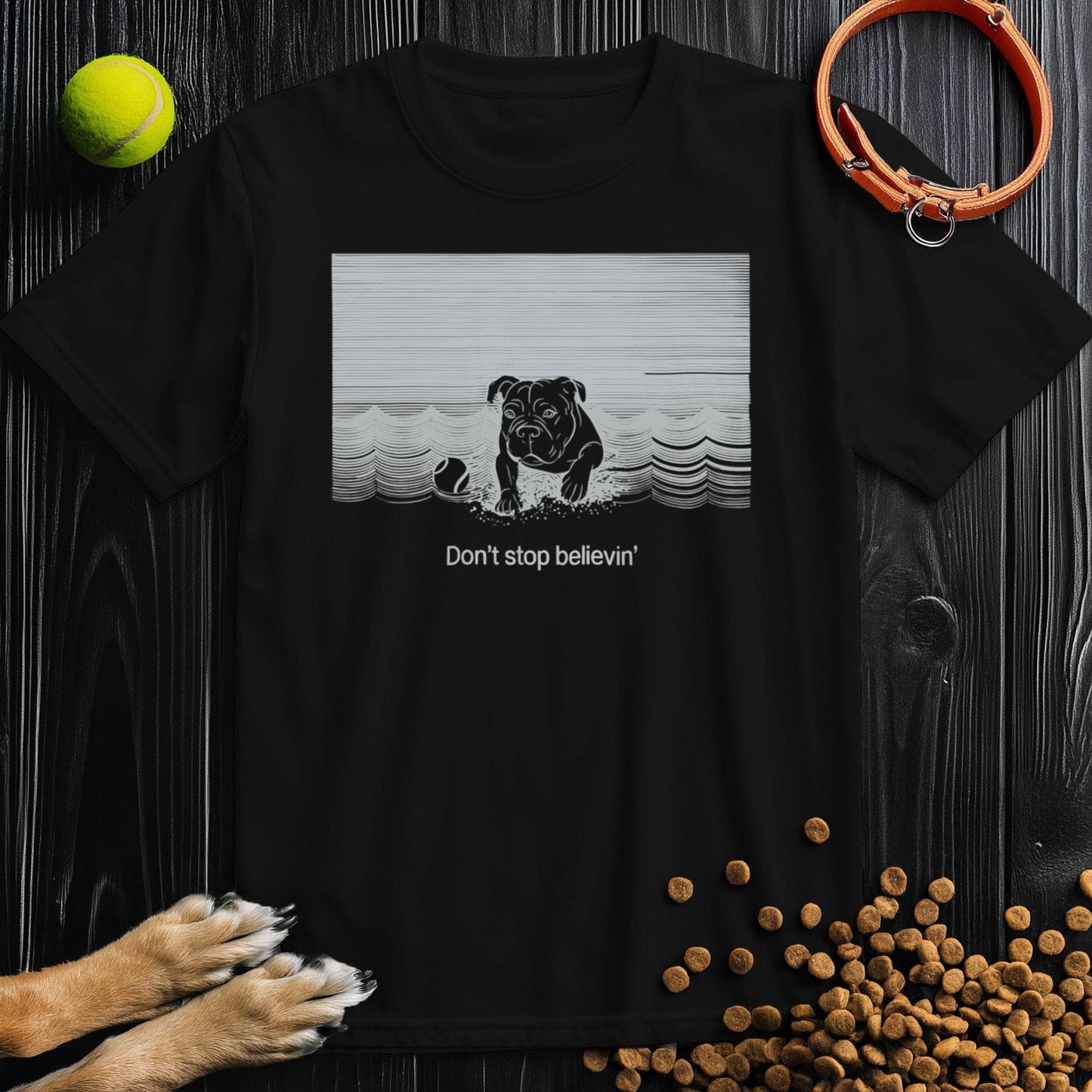 Black Don't Stop Believin Dog T-Shirt featuring a dog graphic and retro waves. 100% cotton unisex dog themed shirt with crew neckline.