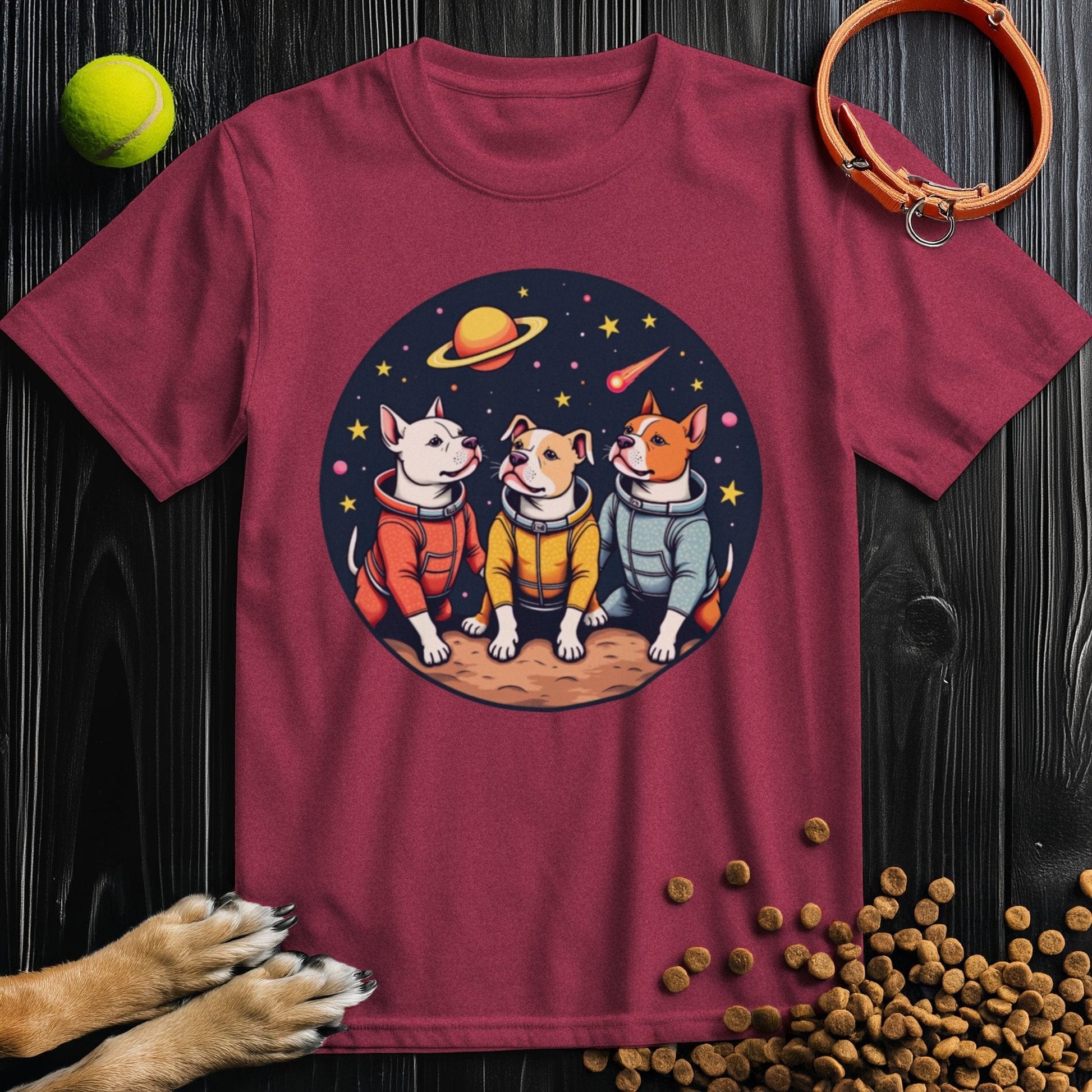 Maroon Cosmic Pits T-Shirt for dog lovers, highlighting three cartoon dogs in space gear with a galaxy-themed backdrop.