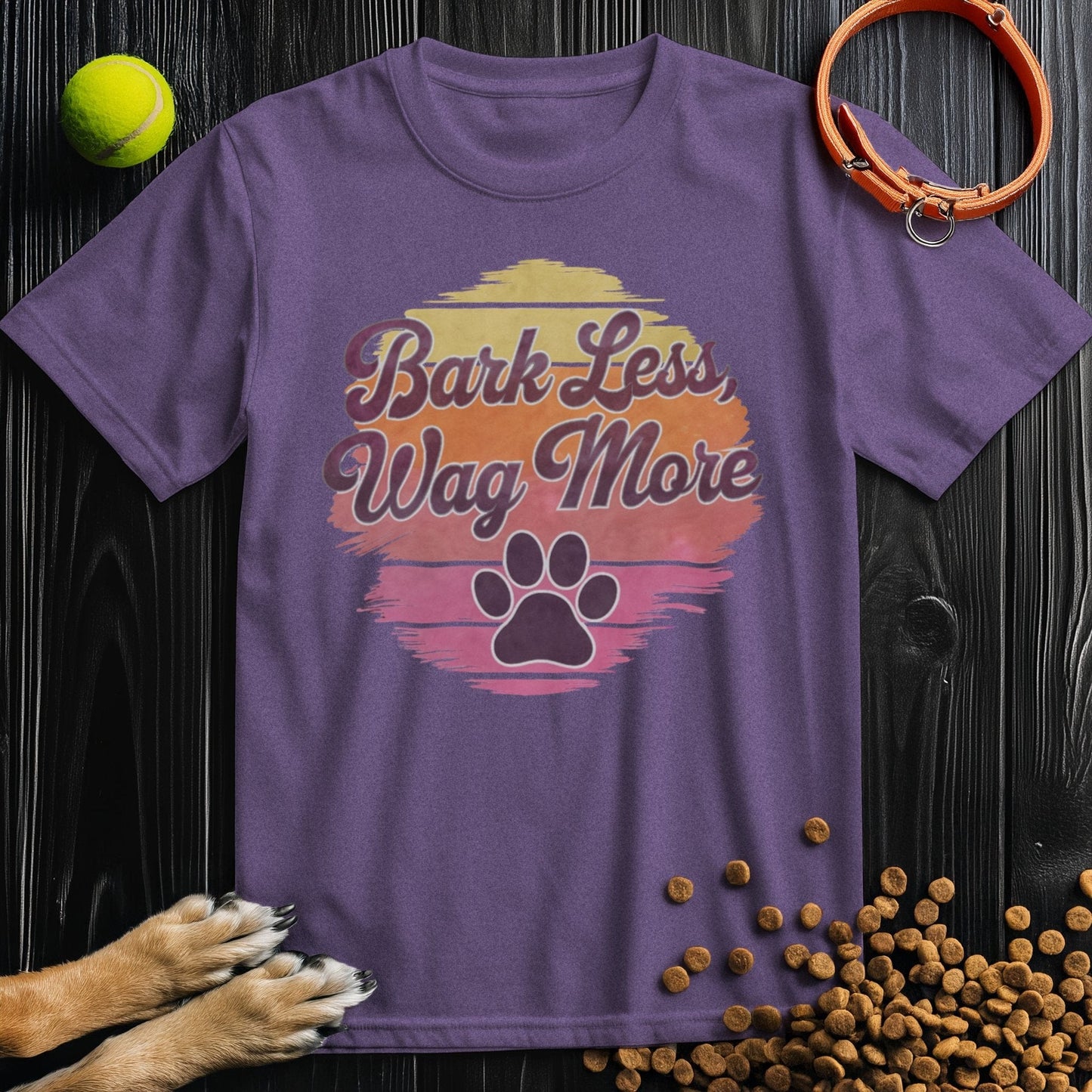 Purple Bark Less, Wag More T-Shirt for dog lovers featuring a sunset design and paw print. Made from 100% cotton, unisex fit.