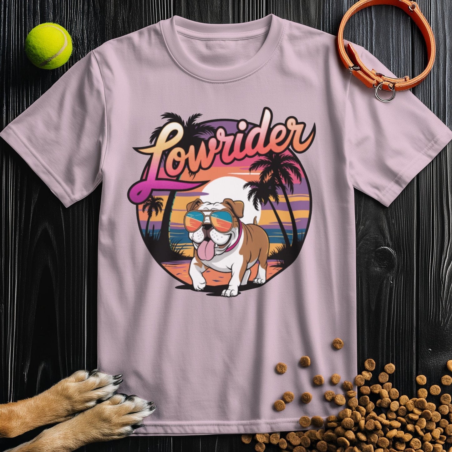 Light pink Lowrider Bulldog Sunset T-Shirt with a playful bulldog in sunglasses and sunset scene. Soft cotton tee ideal for warm weather style.