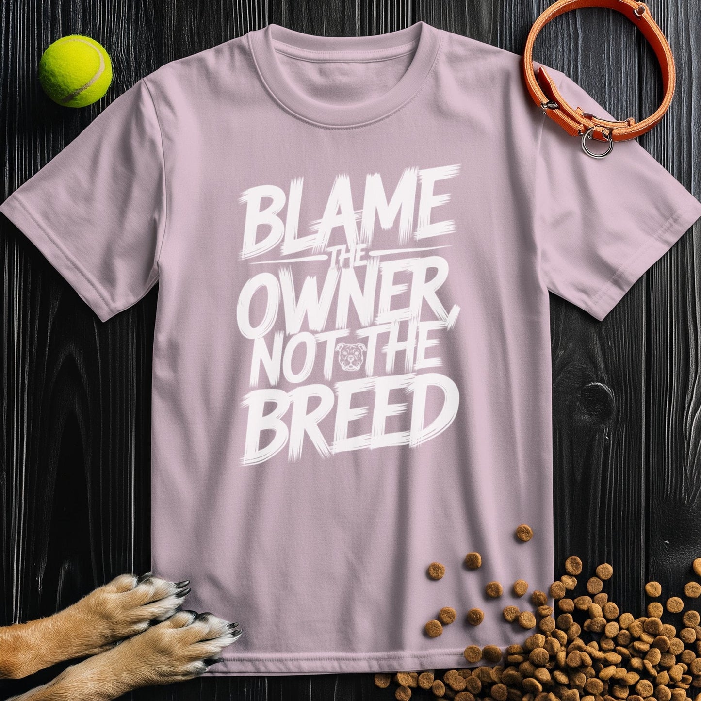 Light pink Pitbull T-Shirt featuring 'Blame The Owner, Not The Breed' slogan. Comfortable 100% cotton, great for pet-friendly fashion.