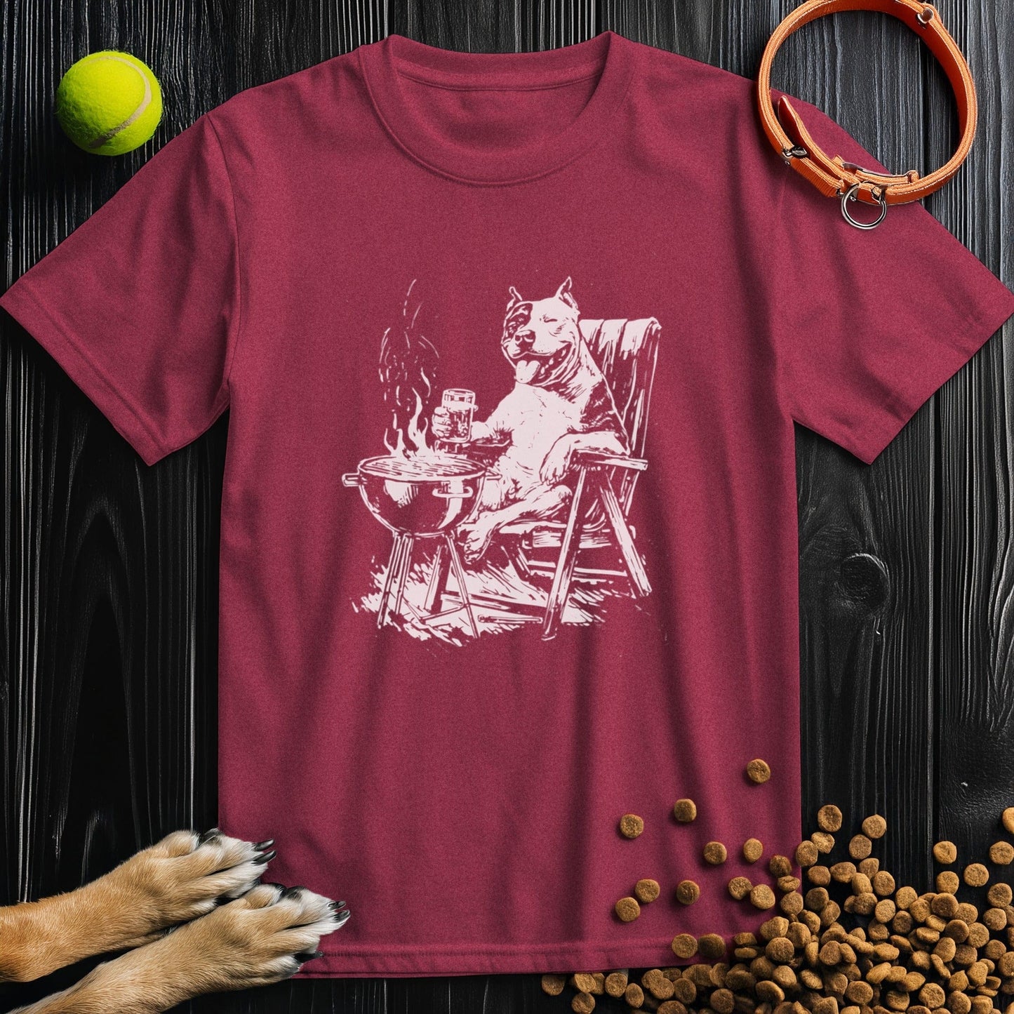 Dog mom and dad tee with relaxed roasting slogan in white on a heather cardinal tee of a pitbull cooking out
