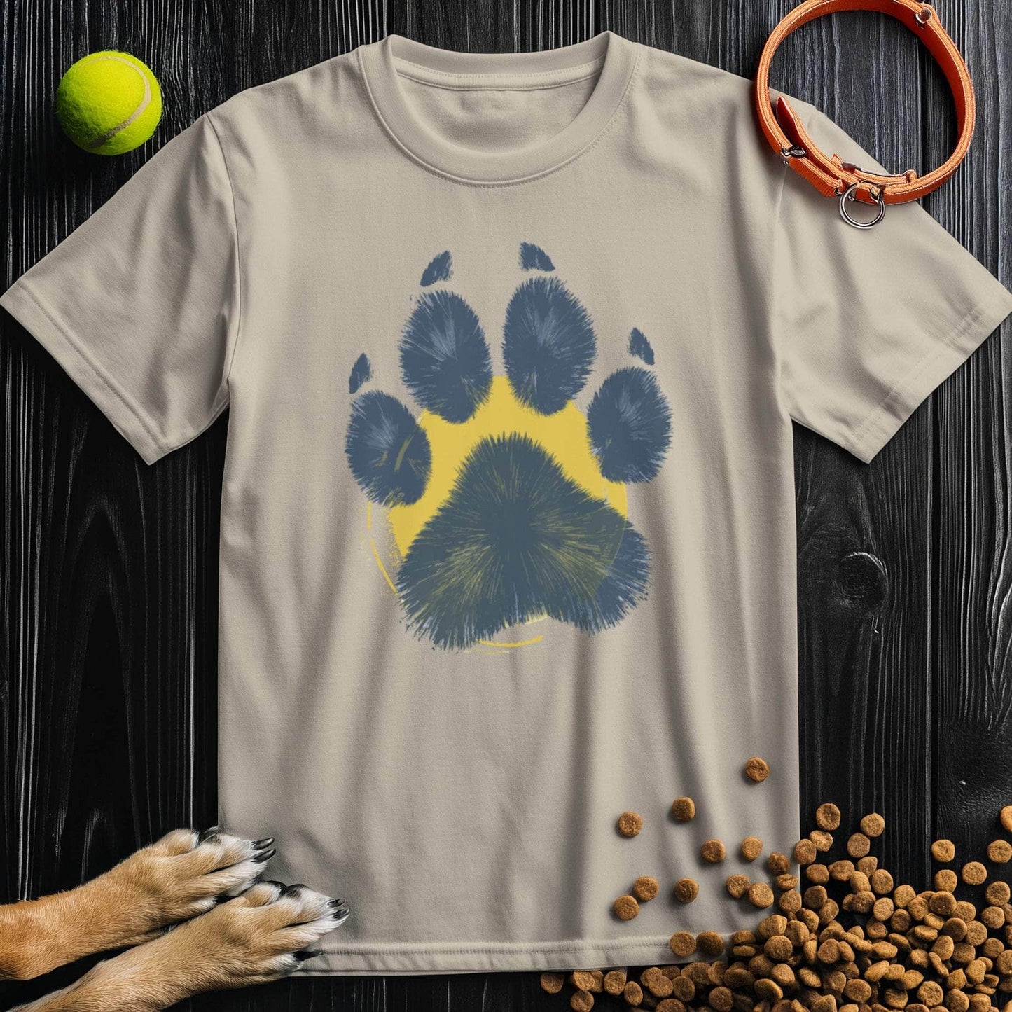 Beige Painter’s Paw T-Shirt featuring a blue paw print on yellow circle. Soft cotton unisex dog lover shirt for all-season comfort and style.