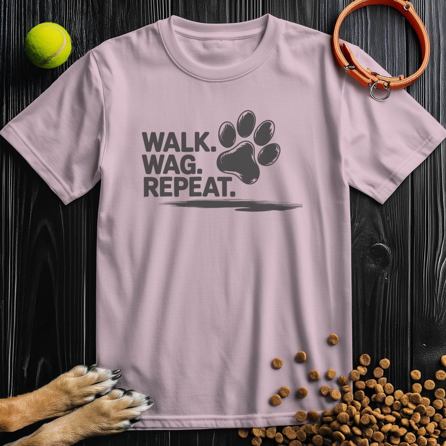 Light pink Walk Wag Repeat T-Shirt with black paw print design, soft cotton tee for dog lovers, casual and stylish.
