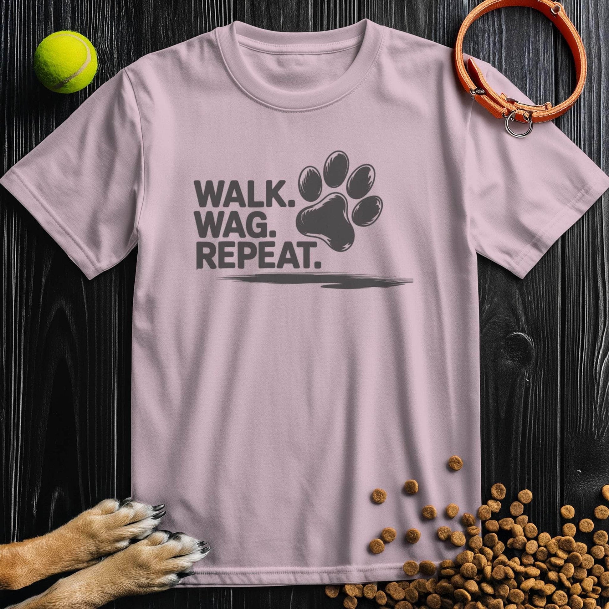 Light pink Walk Wag Repeat T-Shirt with black paw print design, soft cotton tee for dog lovers, casual and stylish.