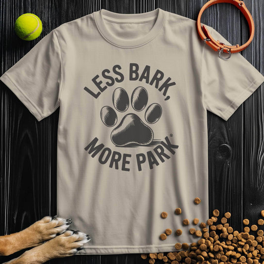 Beige Less Bark More Park T-Shirt featuring black paw print graphic. 100% cotton unisex dog-themed tee for casual wear.