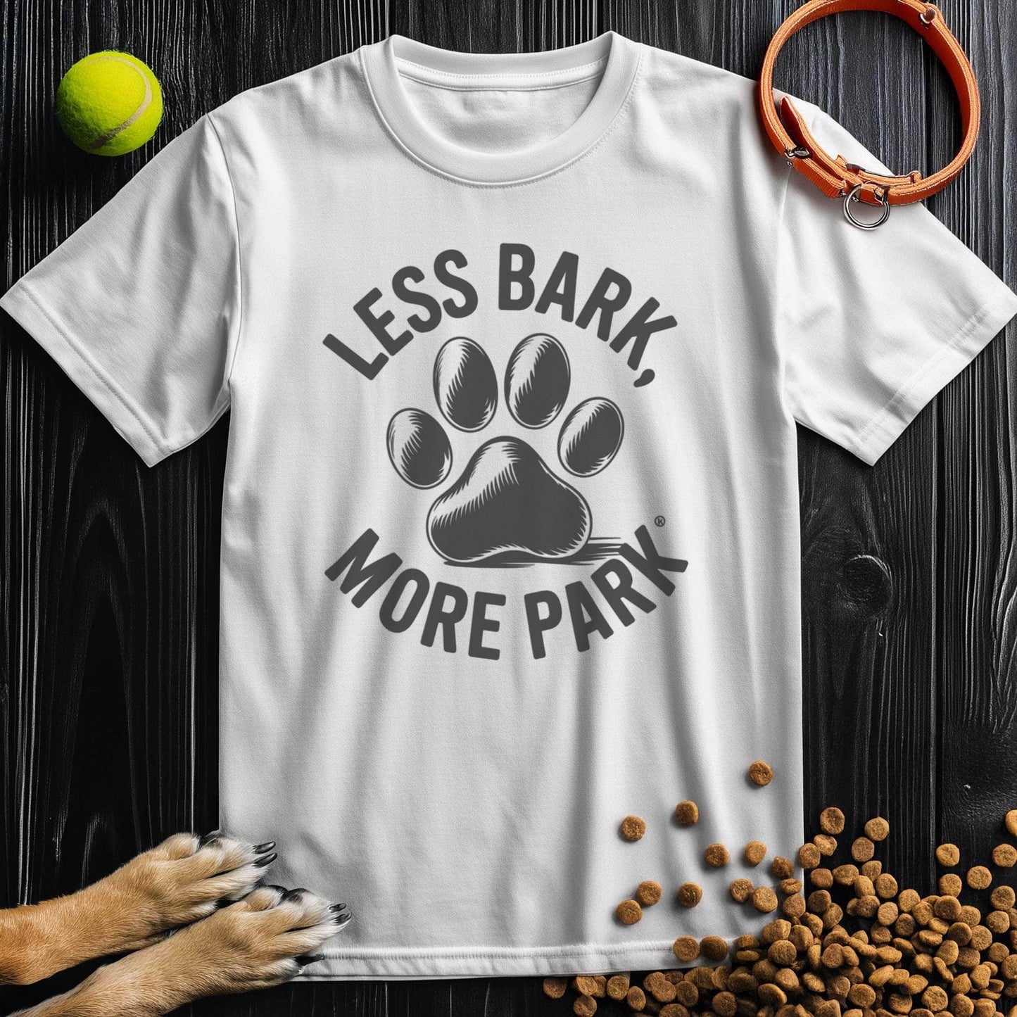 White Less Bark More Park T-Shirt with bold black paw print design. Unisex cotton tee ideal for dog lovers and park outings.