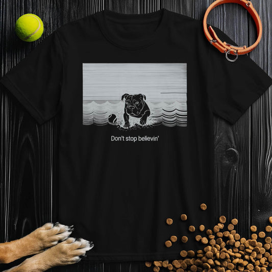 Black Don't Stop Believin Dog T-Shirt featuring a dog graphic and retro waves. 100% cotton unisex dog themed shirt with crew neckline.